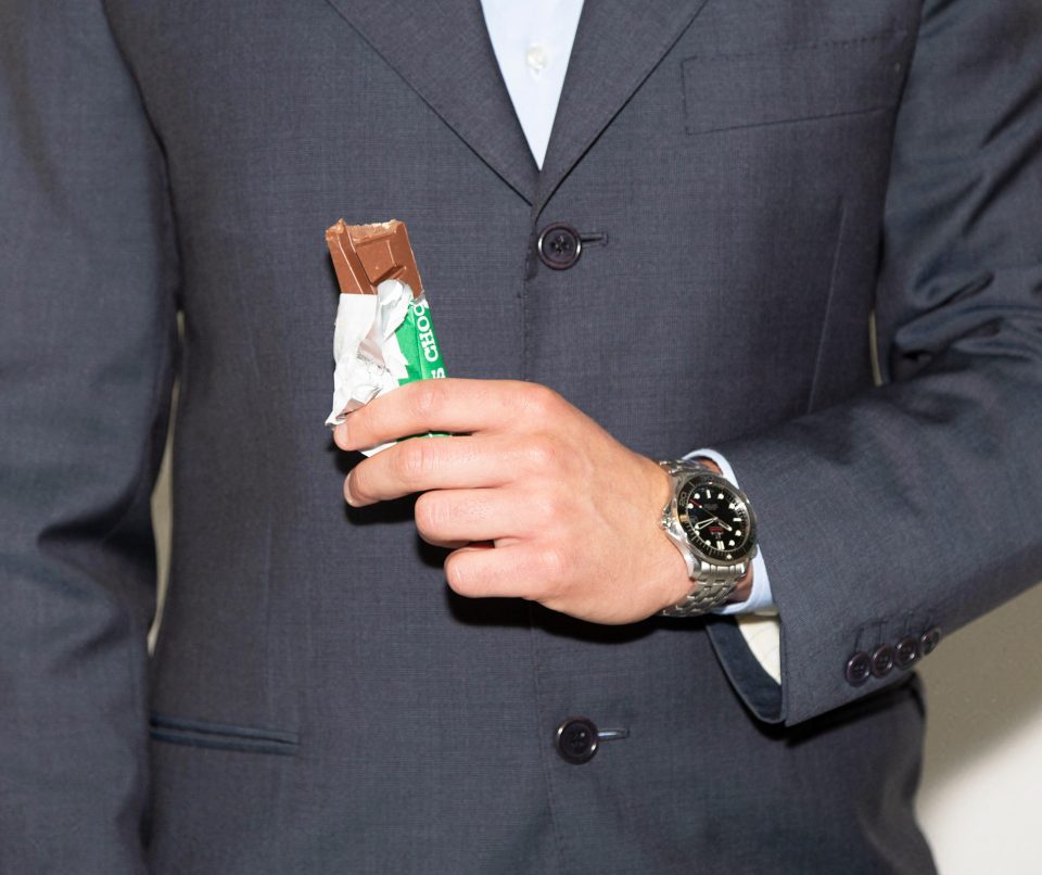 man in suit eating tony chocolate